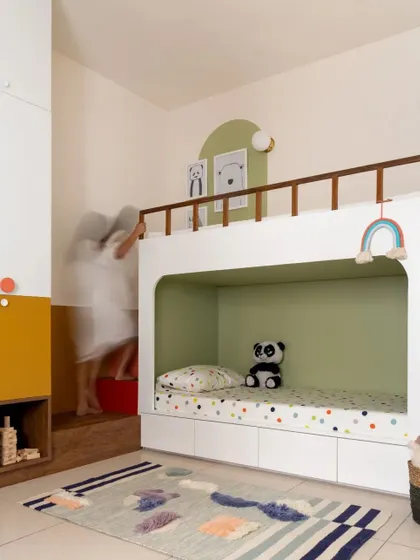 A motion-blur shot capturing the dynamic use of the custom-designed bunk bed and integrated staircase in the children's room.