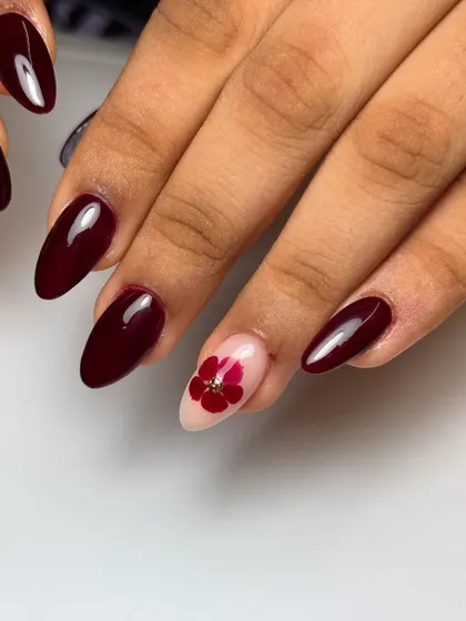 Another view of the elegant berry red set. The almond shape of the nails enhances the sophisticated feel of this classic color.