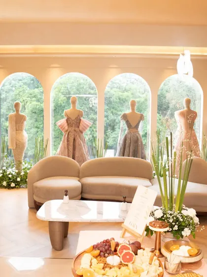 A wide shot capturing the elegant ambiance of a luxury boutique event. My grazing board is perfectly integrated into the chic decor, offering guests a taste of luxury while they browse the latest couture collections.