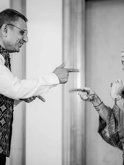 A playful dance-off between the older generation. This black and white photo captures a moment of pure fun and personality.