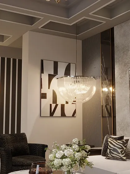 A close-up of the seating area in the basement living room. The abstract art, textured pillows, and modern light fixtures come together to create a cohesive and stylish look.
