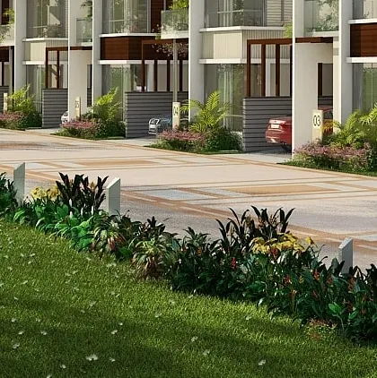 The street view of the Hennur row house community, showing the landscaped common areas and organized driveways for each unit.