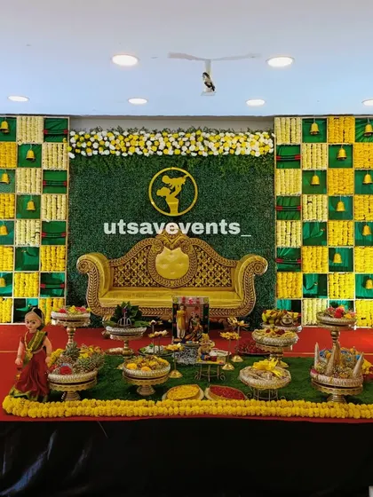 A closer look at the baby shower stage, focusing on the detailed arrangement of sweets and savories (plate decor) placed in front of the main seating area.
