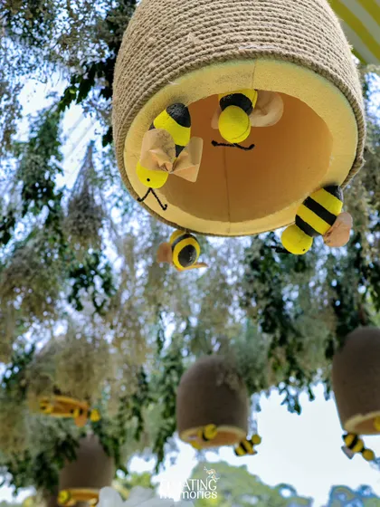 A closer look at our charming, handmade beehives, complete with cute little bees peeking out. These were hung from the trees and canopy, adding a playful and thematic detail throughout the space.