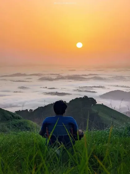 Watching the sunrise above the clouds from a peak in Wayanad. It's a truly heavenly experience.