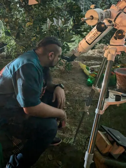 A guest intently observing the night sky through the telescope.
