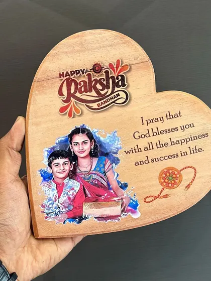 A heart-shaped wooden plaque for Raksha Bandhan, printed with a custom photo and a heartfelt prayer.