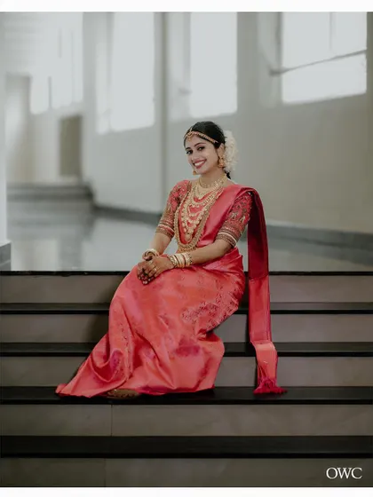An elegant bridal portrait on a staircase, the bride's expression full of grace.