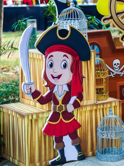 A cute pirate girl cutout, adding to the adventurous atmosphere of the pirate-themed party section.