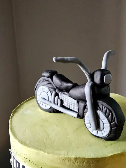 A close-up of the hand-sculpted motorcycle topper. I focused on getting the details of the engine and wheels right to make it look as realistic as possible.