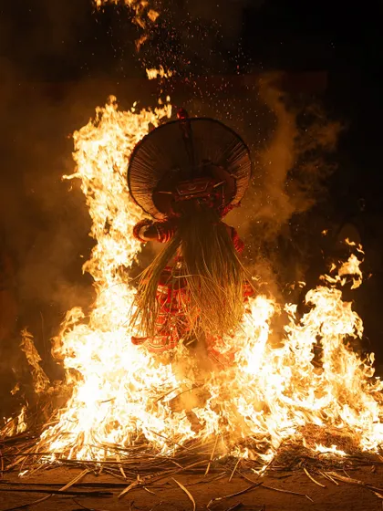 A sequence documenting the Kandanar Kelan Theyyam's fearless dance through fire. These images show the performer's complete surrender to the flames, a testament to the ritual's power.
