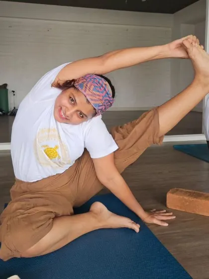 The smile of a student in Suryayantrasana shows the joy that comes with mastering a challenging and beautiful pose in our TTC.