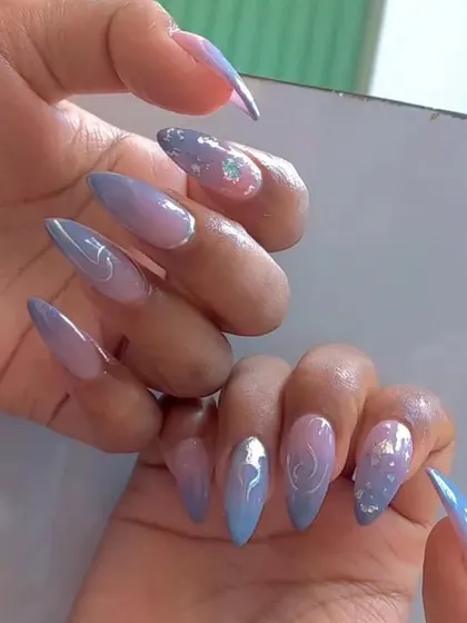 A dreamy abstract design with a pastel blue and purple ombré, accented with silver swirls and glitter.