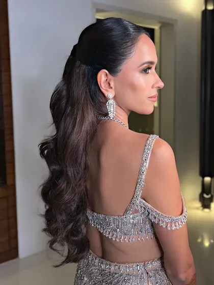 A side profile of the glamorous half-ponytail, showing its volume and elegant shape.