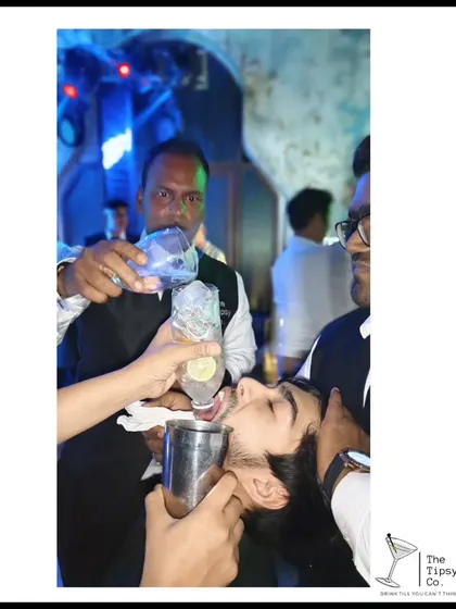A fun and slightly wild moment where our bartenders help a guest take a 'long shot'. It's all about creating a high-energy, unforgettable party atmosphere.