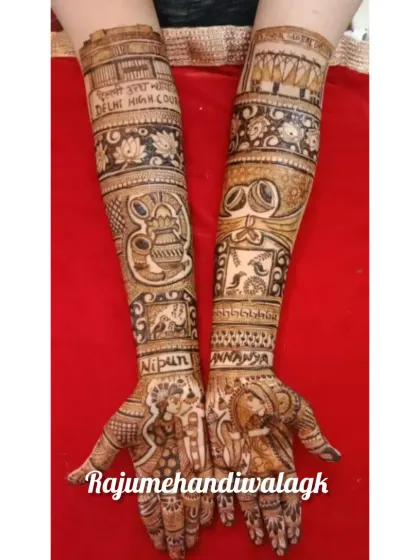 A personalized design where the couple's names, Nipun and Ananya, are written on the palms along with their portraits. The arms feature symbols from their story, including the Delhi High Court.