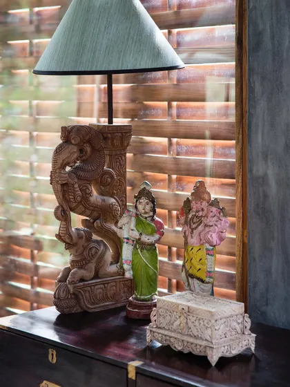 A collection of Indian crafts and a carved wooden lamp base add character and a sense of place to an interior at Jalakara.