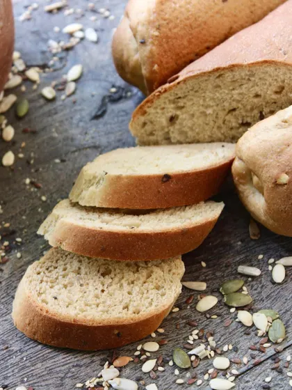 A close-up of our freshly sliced whole-wheat baguette. You can see the soft texture and the goodness of the mixed seeds baked right in.