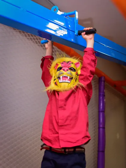 Roaring into some fun! This little lion is having a great time exploring the play structure and showing off his strength.