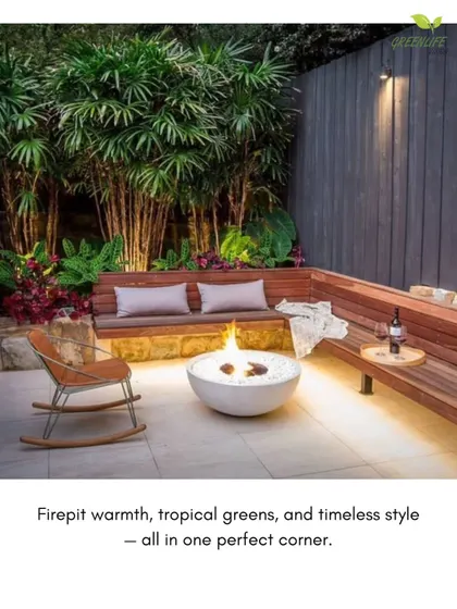 A cozy firepit corner perfect for relaxing. This design features a modern bowl firepit, a curved wooden bench, and tropical foliage to create a warm and inviting atmosphere.