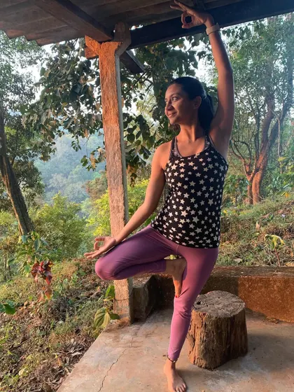 A joyful variation of Vrikshasana, or tree pose, in a rustic, wooded area. Balancing on uneven ground challenges the body and mind, reminding me to stay adaptable and find grace in every moment.