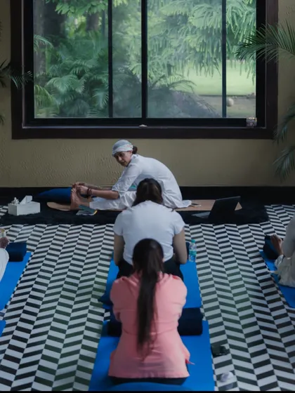 A view from the back of our class, showing the shared focus and dedication of the Sangat. I often provide gentle adjustments to help students deepen their practice safely.