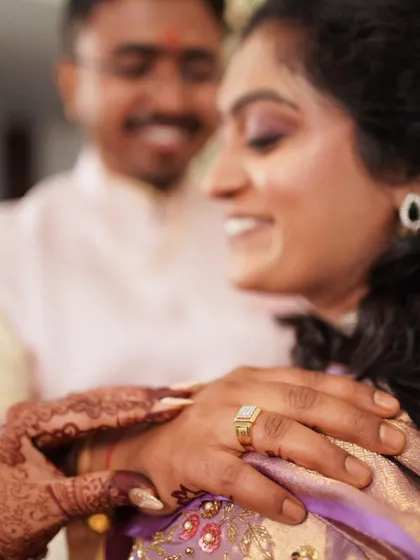 A tender moment between the newly engaged couple, filled with soft smiles and affection.