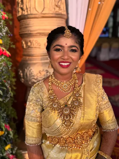 A beautiful, happy shot of a bride in her golden wedding saree. My goal is to create makeup that allows the bride's natural joy to shine through, without being hidden under heavy layers.