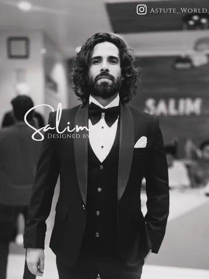 A client looking sharp in a classic black three-piece tuxedo. This is the epitome of timeless formal wear, tailored for a perfect fit.