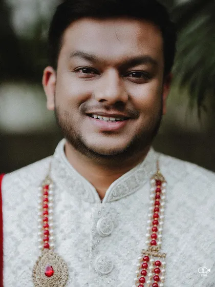 A duplicate of the groom's happy close-up portrait.