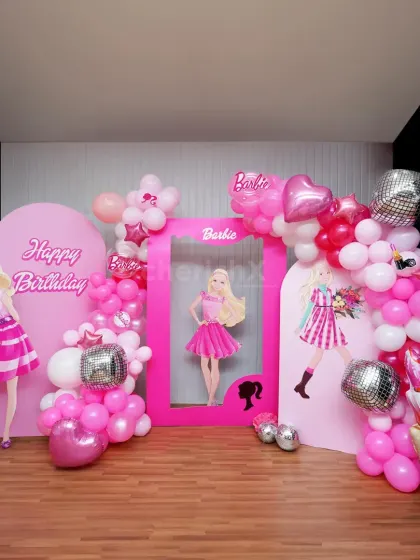 A full-scale Barbie dream party in the making. This setup includes multiple themed backdrops, a life-sized Barbie photo frame, character cutouts, and an explosion of pink balloons with disco ball accents for that extra sparkle.