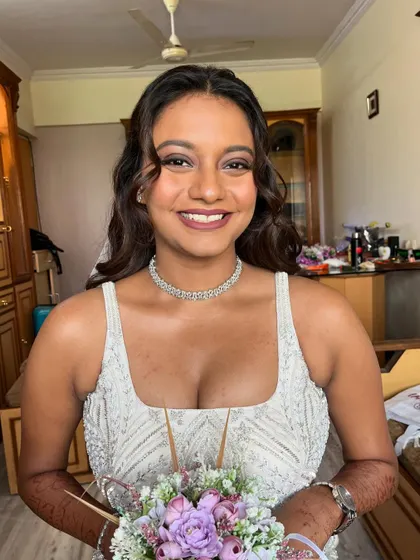 A final portrait of the bride, her smile radiating love and grace. The makeup is timeless and perfectly suited for her fairytale wedding.