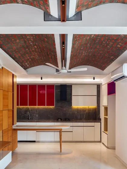 Another perspective of the kitchen and living space, highlighting the unique texture of the brick vault ceiling against the clean lines of the modern kitchen.