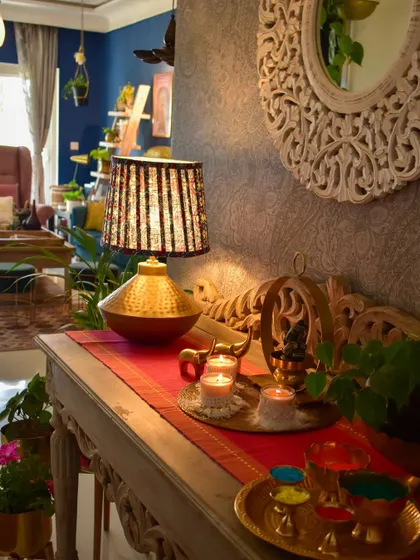 A close-up of my foyer console table. The block-print lamp, the brass accents, and the pop of pink from the runner create a vibrant, eclectic look.