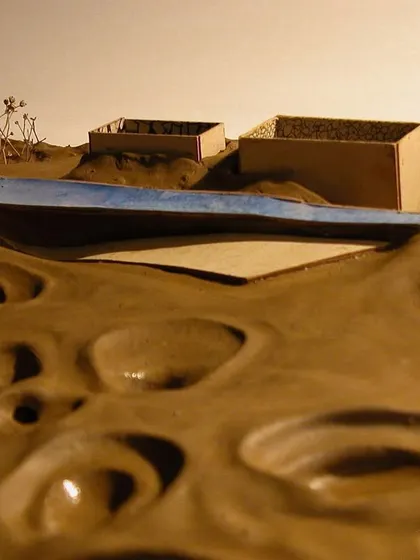 The model illustrates the concept of a new, clean plane (represented by the blue element) being superimposed over the damaged earth, symbolizing a path toward healing and recuperation.