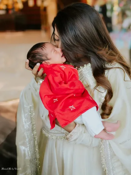 A mother's gentle kiss for her newborn son. This is a memory of pure, unconditional love.