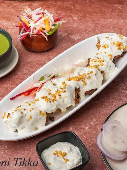 For garlic lovers, our Dahi Lasooni Tikka is a must-try. Tender chicken is marinated in a yogurt and garlic-heavy mixture, then grilled to create a creamy, pungent, and delicious kebab.