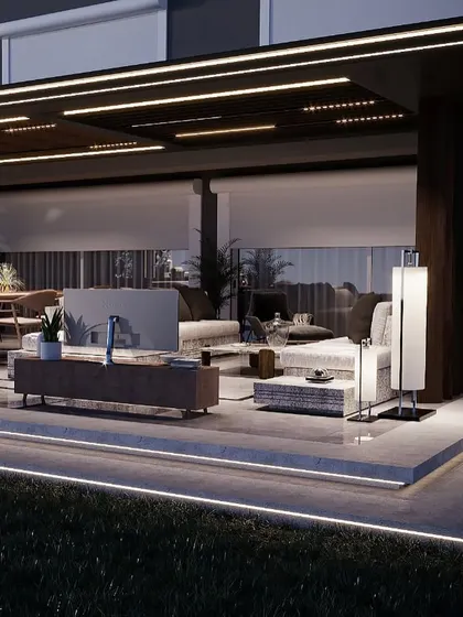 This view highlights the layered lighting design of the backyard project, with LED strips along the platform edge, recessed ceiling lights, and accent sconces. This creates a warm, inviting glow throughout the entire outdoor living space.