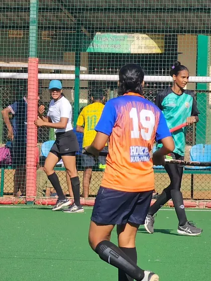 A view from behind as our player, number 19, moves into position. Team jerseys help create a strong sense of identity and unity on the field.
