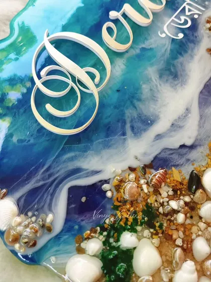 Another detail shot of the ocean nameplate, highlighting the custom lettering and the beautiful blue hues.