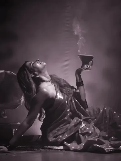 A stunning black and white version of the artistic saree shoot, emphasizing the light, shadow, and smoke.