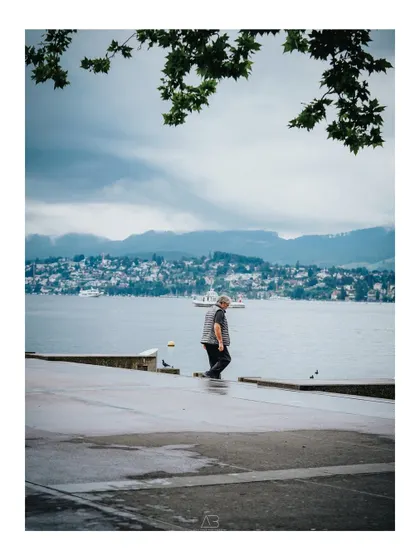 A fleeting moment of a man walking by the lake in Zurich. This is street photography at its core, finding art and story in everyday life.