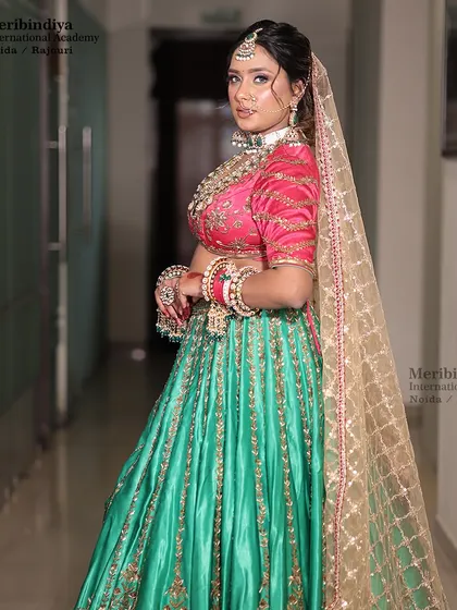 A full-length shot showing the complete bridal look, where the elegant updo balances the heavily embroidered outfit.