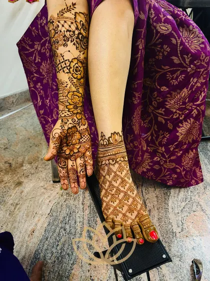 A combined shot of the bride's floral hand mehendi and her geometric foot mehendi, showing how different styles can be beautifully coordinated.