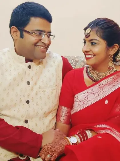 An intimate, smiling moment between Prarthana and Karan. This image captures the warmth and easy connection that comes from a partnership based on a shared spiritual purpose.