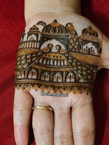 A close-up of the trial mehandi, showing the intricate details of the palace and peacocks.