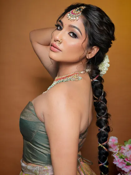 A profile shot showcasing the intricate hairstyle and the beautiful side profile. The makeup is flawless from every angle.