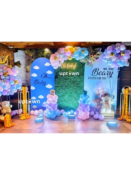 A modern "Oh Baby" themed baby shower with a teddy bear motif and pastel balloons.