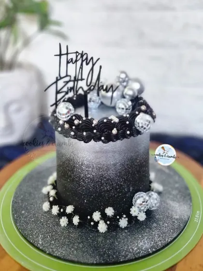 It's time to disco! This black and silver ombre cake is ready for a party, decorated with mini disco balls and sparkling edible glitter.