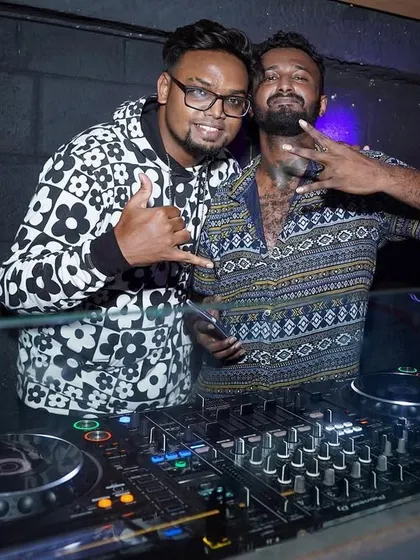 With an MC at a "Major Flava Friday" event. I can arrange for an MC to host your party, engage the crowd, and take your event to the next level.